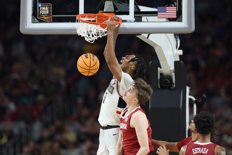 Stephon Castle of UConn dunks the ball in the second half against Alabama in the NCAA Men's  Final Four game at State Farm Stadium on April 6, 2024 in Glendale, Ariz.