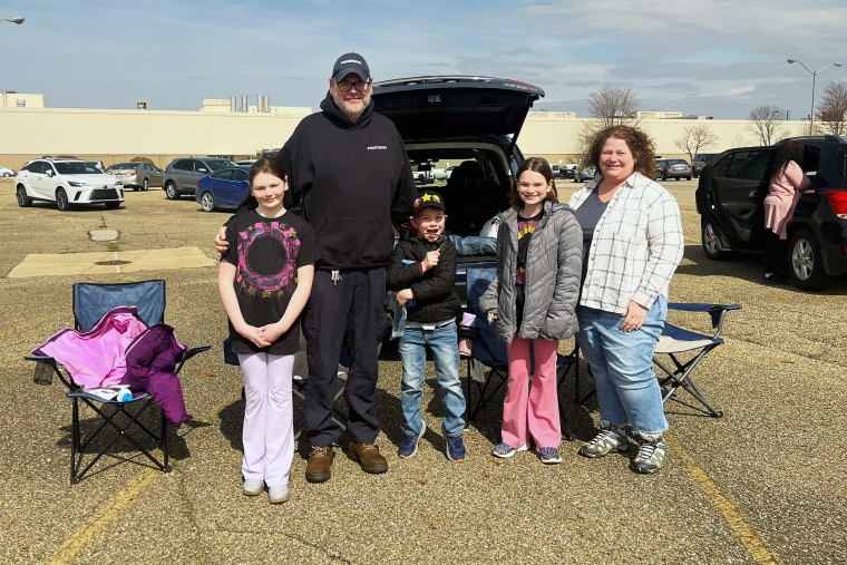Dan Mincks with his family in the parking lot of the Foxconn Electric Vehicle plant in Lordstown, Ohio.