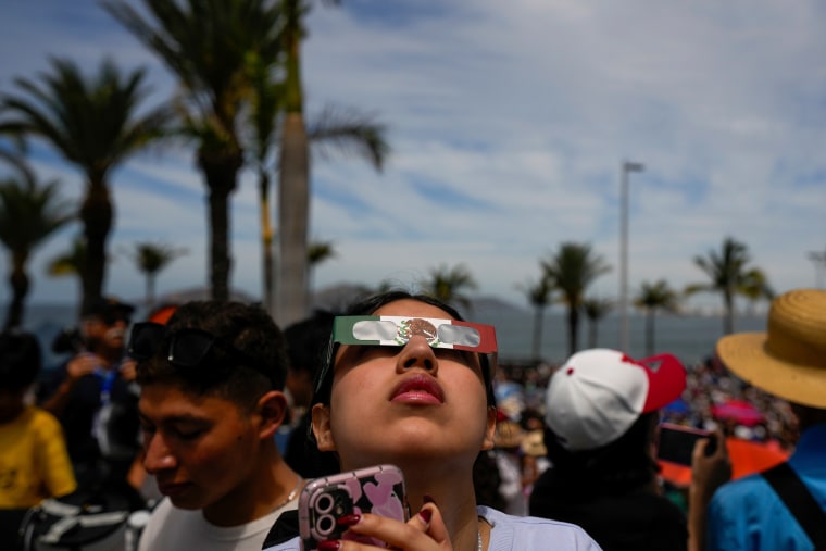 People watch a total solar eclipse in Mazatlan