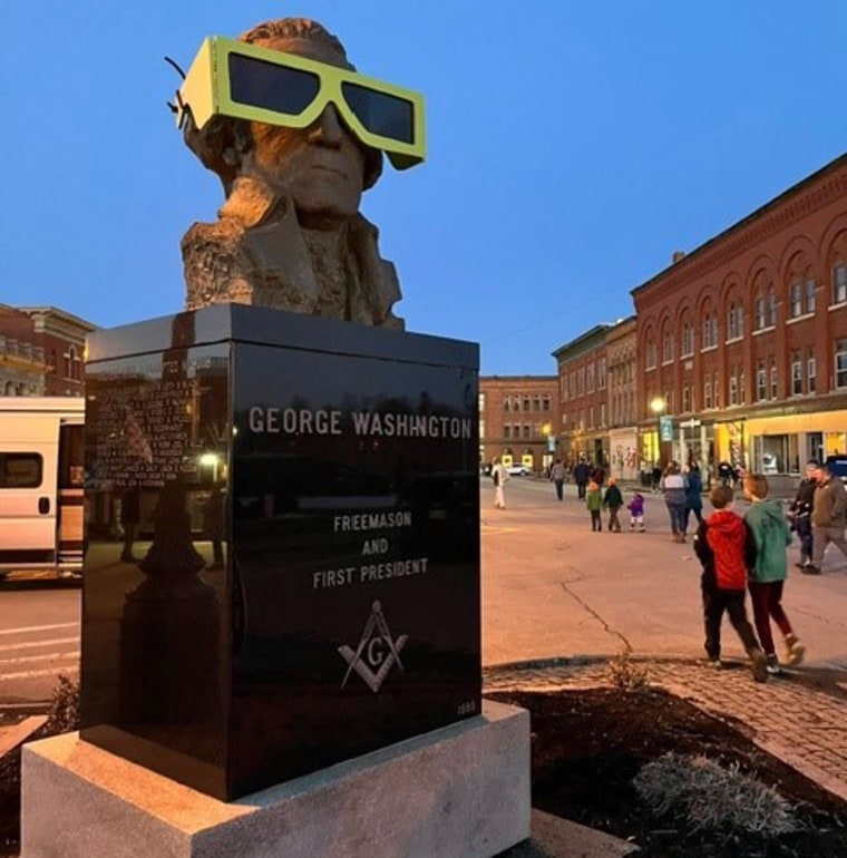 Eclipse glasses cover a bust of George Washington in Houlton, Maine. 
