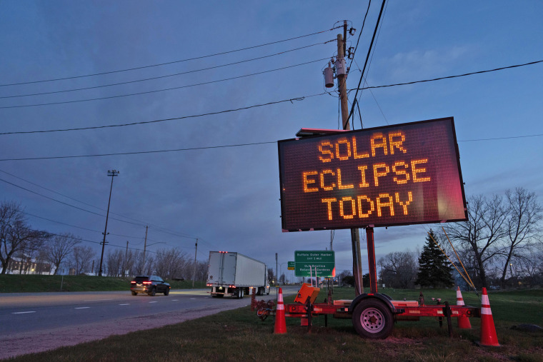 A matrix road sign displays a message for drivers about the solar eclipse on April 8, 2024 in Lackawanna, New York. 