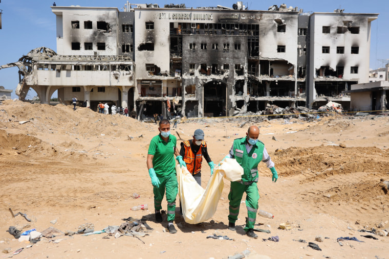 Palestinians recover human remains at the grounds of Al-Shifa hospital, Gaza's largest hospital, on April 8, 2024.