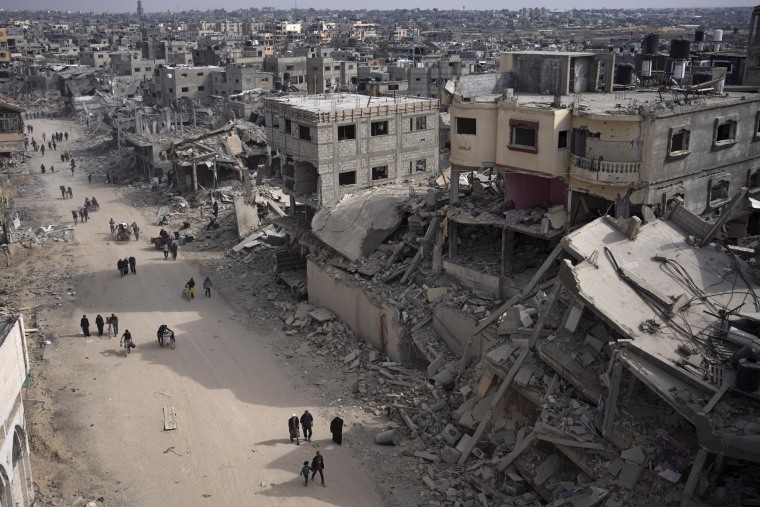 Palestinians walk through the destruction in the wake of an Israeli air and ground offensive in Khan Younis, southern Gaza, on Monday, April 8, 2024.Image: