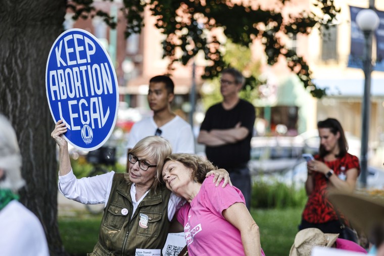 A woman holds a sign saying "Keep Abortion Legal," as demonstrators gather outside the Monroe County Courthouse on July 31, 2023 in Bloomington, Ind.