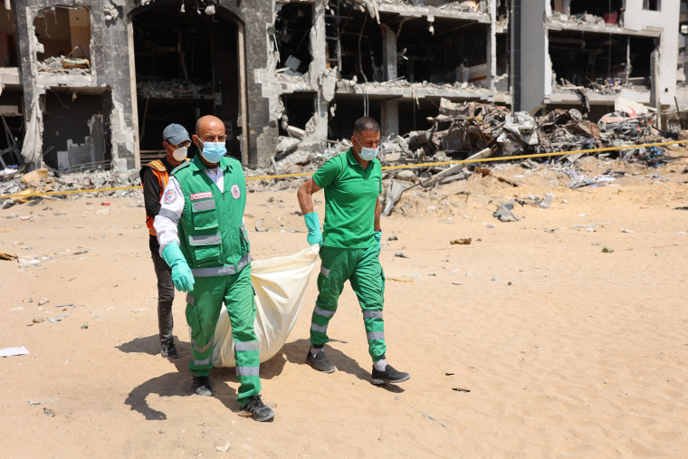 Palestinian forensic and civil defence recover human remains at Al-Shifa hospital in Gaza
