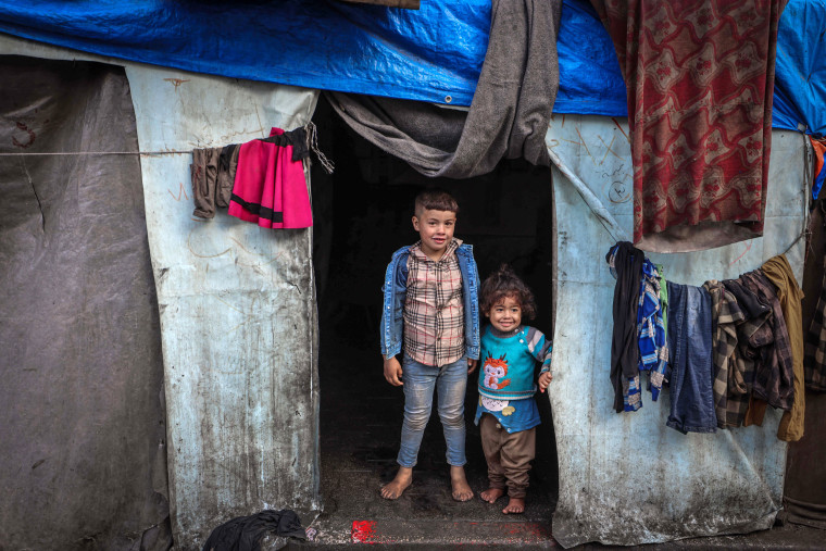 Displaced children stand at their tent in Rafah, southern Gaza Strip, on April 10, 2024.