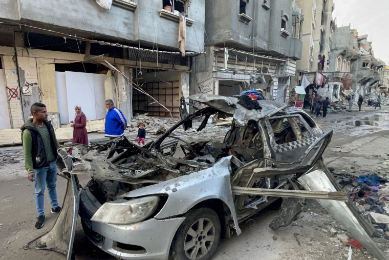Passersby look at the car in which three sons of Hamas leader Ismail Haniyeh were reportedly killed in an Israeli airstrike in al-Shati camp, west of Gaza City, on April 10, 2024.