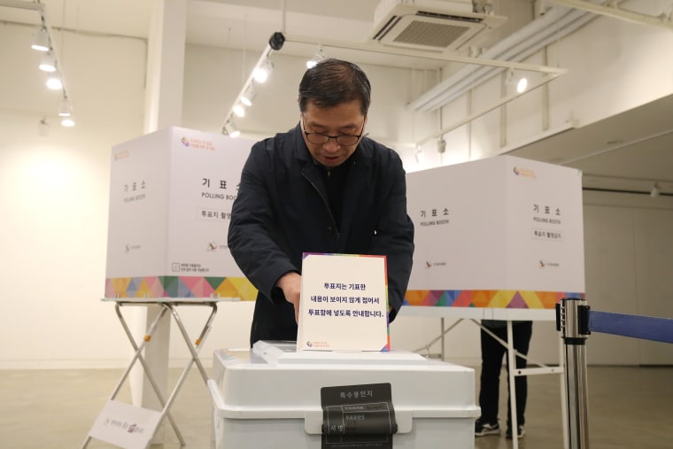A man casts his vote in a polling station on the parliamentary election in Seoul, South Korea