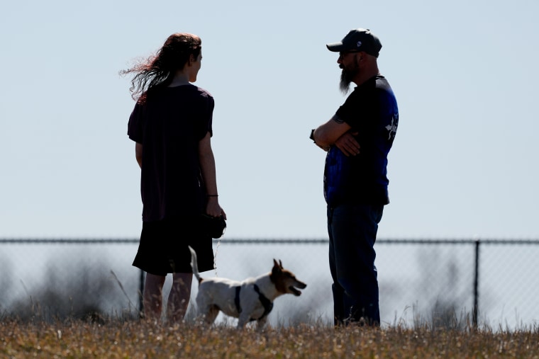 Dusty Farr talks with his daughter at a park