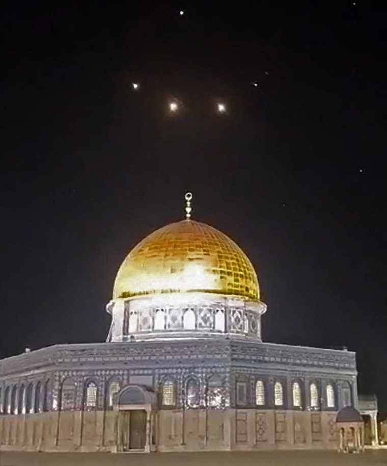 Rocket trails in the sky above the Al-Aqsa Mosque compound in Jerusalem early on April 14, 2024.