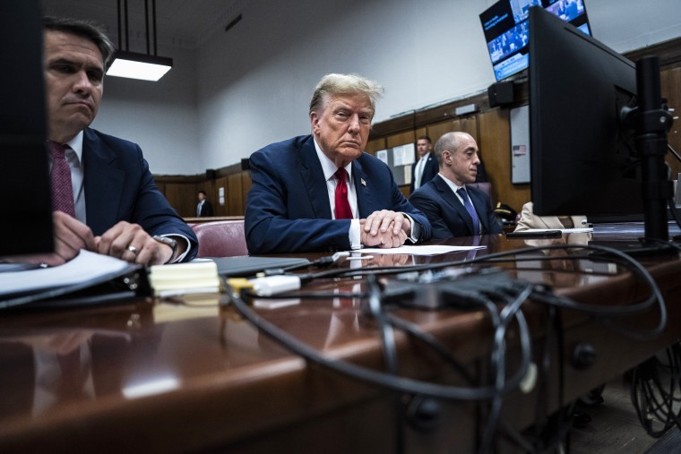 Former President Donald Trump appears with his legal team, Todd Blanche and Emil Bove, right, ahead of the start of jury selection at Manhattan Criminal Court on April 15, 2024 in New York City.