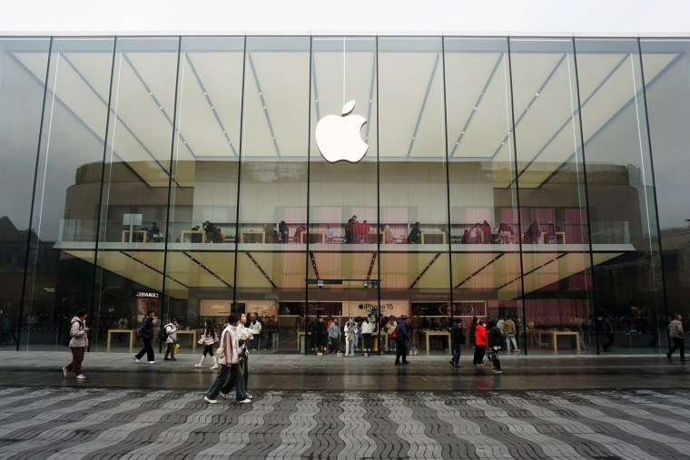 People walk past an Apple flagship store in Hangzhou, China
