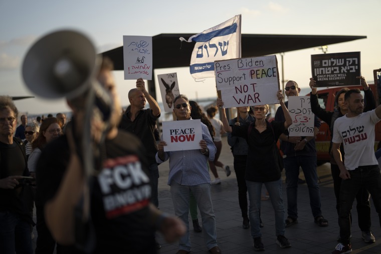 People demonstrate demanding a regional peace agreement outside of the U.S. Embassy Branch Office in Tel Aviv.