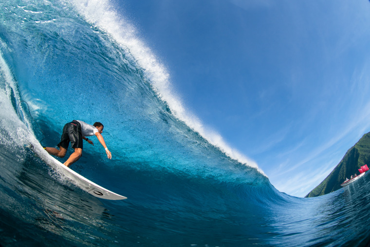 A man surfs in the village of Teahupoʻo in Tahiti