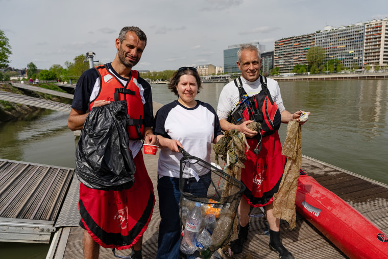 Kayakers Paul Maakad, Sarah Birden and Vincent Darnet with the trash they collected from the Seine.