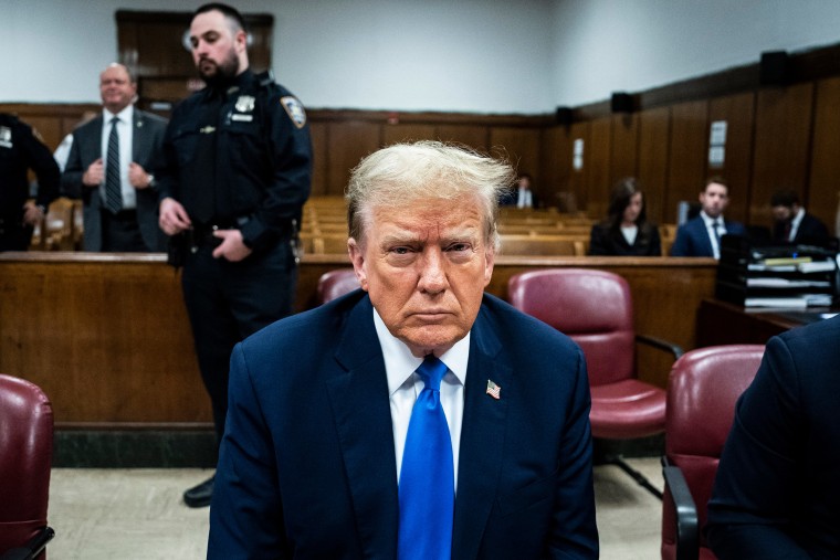 Donald Trump sits in court