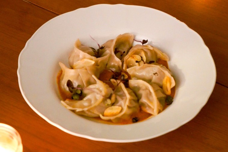 Steamed beef momos in sesame tomato sauce.