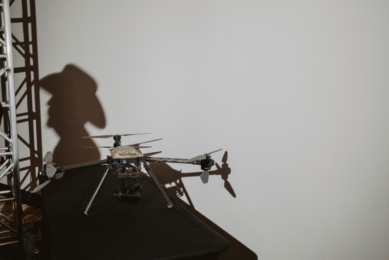 A drone acts as a prop for a conspiracy-filled presentation on child trafficking.