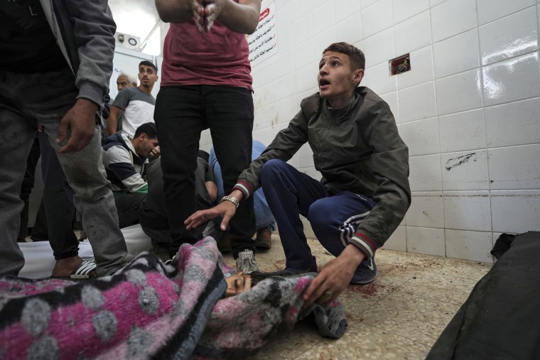 A Palestinian reacts to seeing the young victim of an Israeli airstrike, at Al Aqsa Hospital in Deir al Balah, central Gaza, Monday, April 22, 2024.