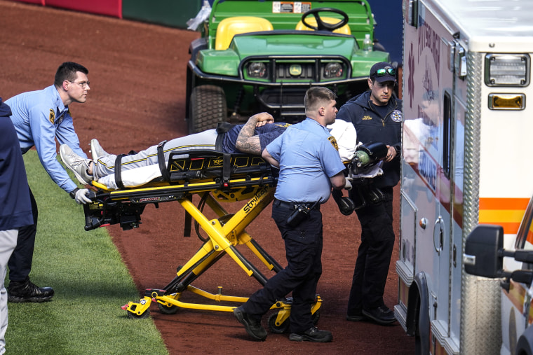 Milwaukee Brewers pitcher Jakob Junis is wheeled to an ambulance 