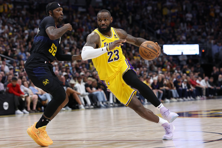LeBron James of the Los Angeles Lakers drives against Kentavious Caldwell-Pope of the Denver Nuggets in the fourth quarter during game two of the Western Conference First Round Playoffs at Ball Arena on April 22, 2024 in Denver.