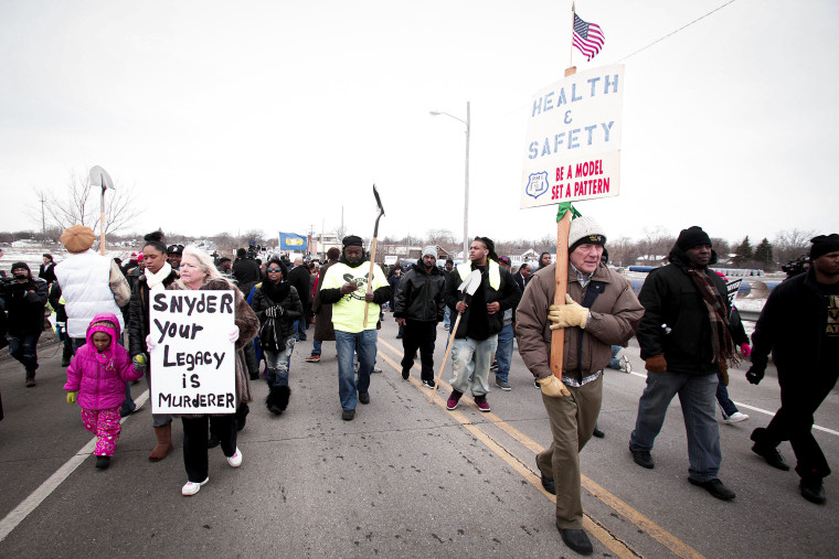 People participate in a national mile-long march to highlight the push for clean water in Flint