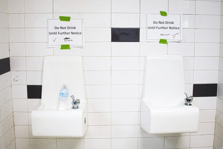 Placards posted above water fountains.