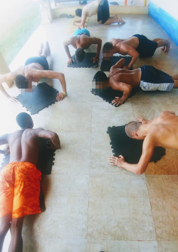 Boys do pushups at Atlantis Leadership Academy. Faces have been obscured by NBC News.