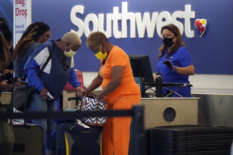Travelers line up at a Southwest Airlines ticket counter at Los Angeles International Airpor