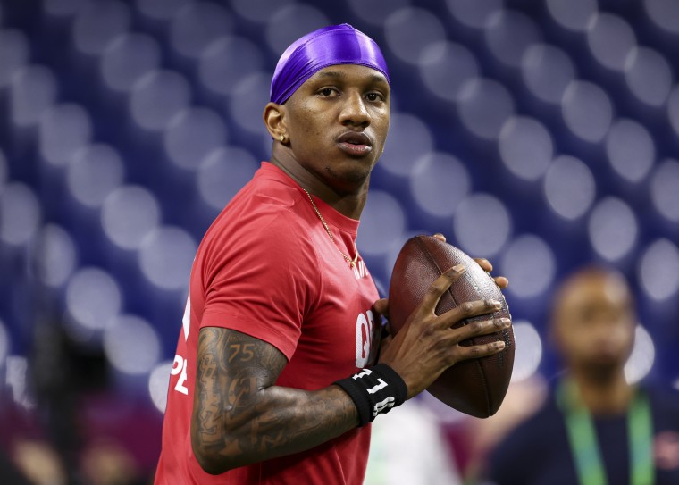 Michael Penix prepares to throw a football during the NFL Combine in Indianapolis.