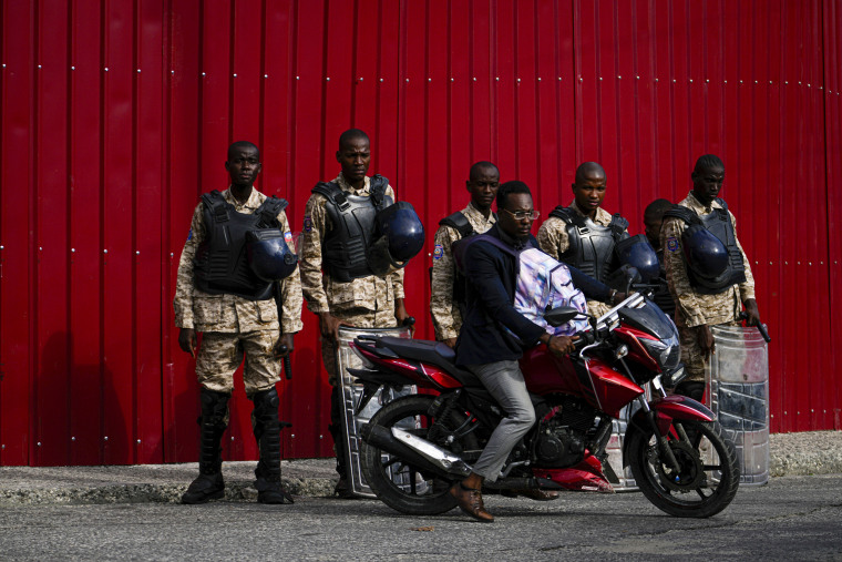 Police stand guard outside the Prime Minister's office in Port-au-Prince.