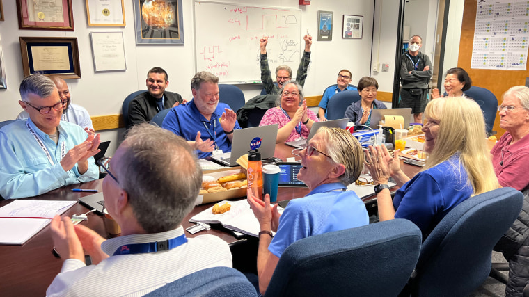 Members of the Voyager flight team celebrate in a conference room at NASA’s Jet Propulsion Laboratory on April 20. 