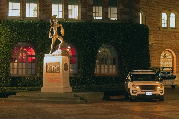 A USC Department of Public Safety vehicle sits next to the base of the Tommy Trojan statue