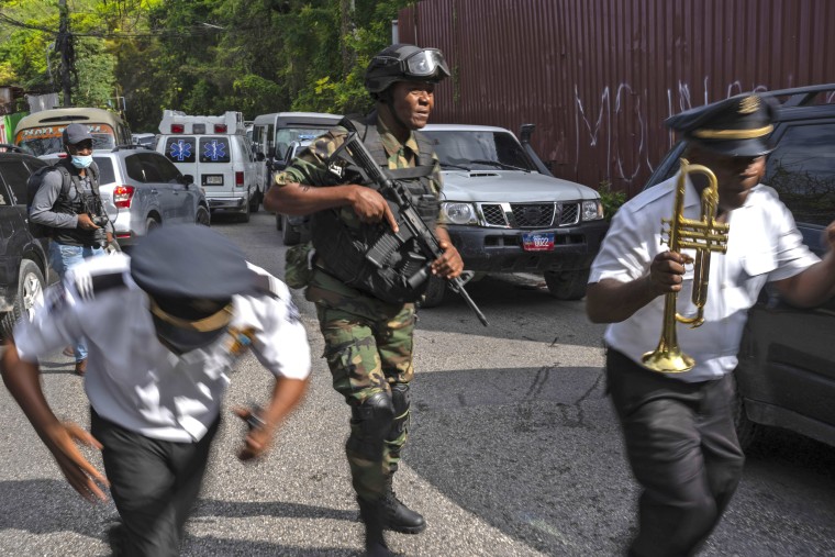 Police escort musicians arriving for the swearing-in ceremony of a transitional council tasked with selecting a new prime minister and cabinet at the Prime Minister's office in Port-au-Prince, Haiti, Thursday, April 25, 2024.