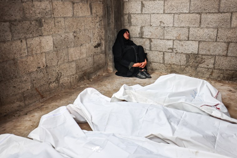 A Palestinian mourns relatives killed in Israeli bombardment