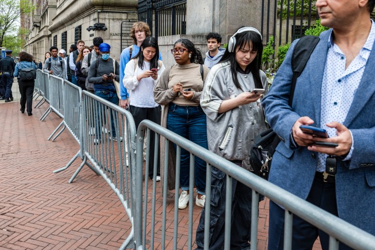 Columbia University students and personnel wait in line
