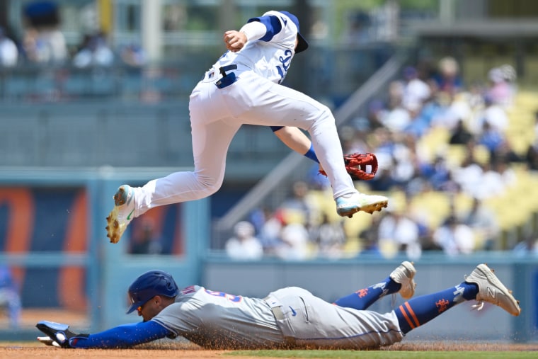     Brandon Nimmo #9 of the New York Mets steals second base in the first inning when Gavin Lux #9 of the Los Angeles Dodgers gets a late throw at Dodger Stadium on April 20, 2024 in Los Angeles, 