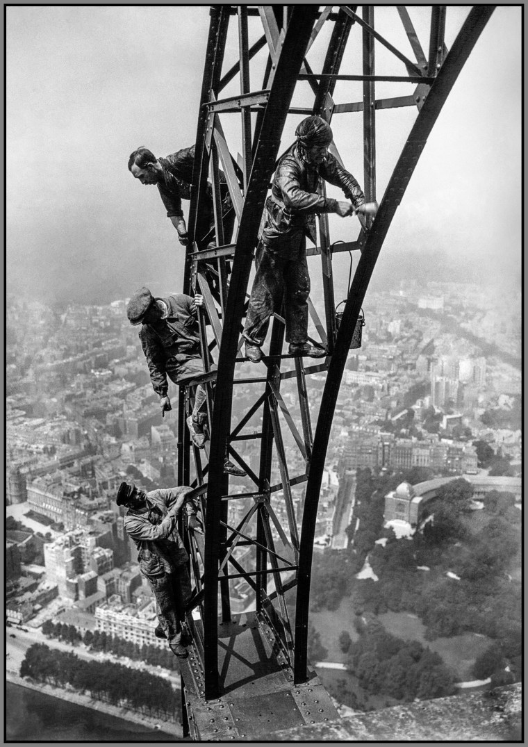 Men repainting the beams of the Eiffel Tower in August 1924 