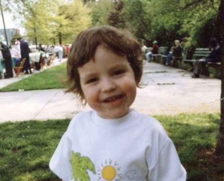 Dr. Kerry Magro as a child smiling in a picture outside