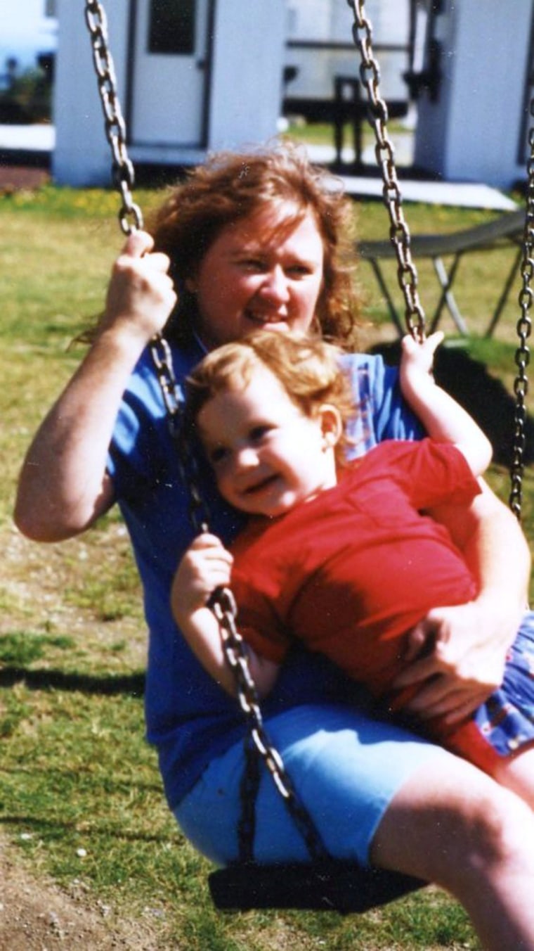 Dr. Kerry Magro as a child swinging in his mothers lap outside