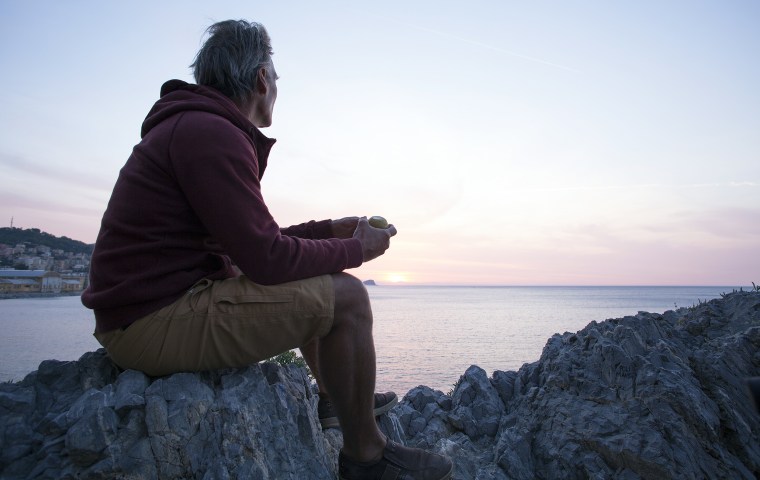Man watching sunrise as sea
