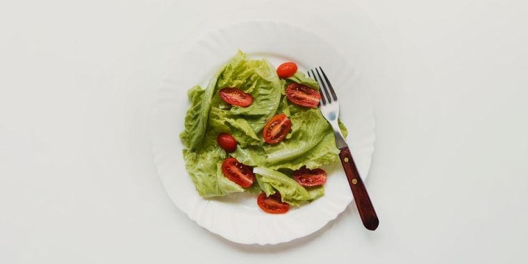 healthy plate of salad with lettuce and tomato flat layer