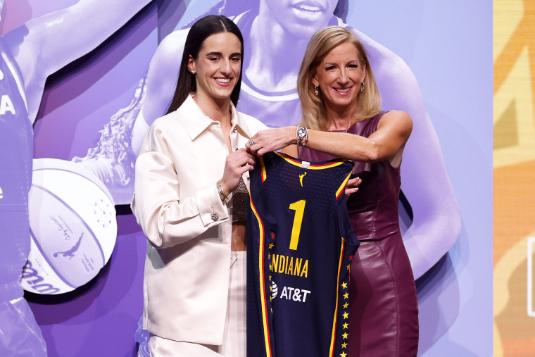 Caitlin Clark poses with WNBA Commissioner Cathy Engelbert after Indiana Fever selects her with first pick in 2024 WNBA draft.