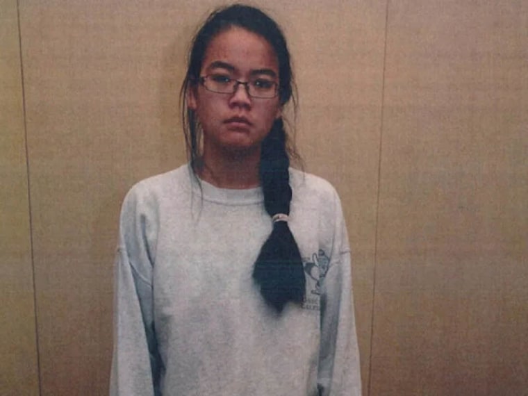 Jennifer Pan in a sweatshirt and glasses with her dark hair in long braid. 