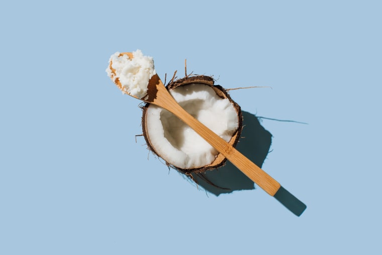 Ripe coconuts, coconut oil on blue background. 