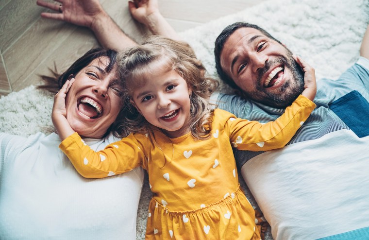 Fun portrait of two parents and a small girl