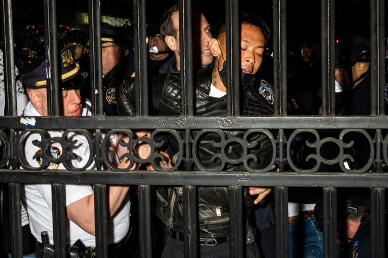 The NYPD arrest protesters outside the gates of Columbia University.
