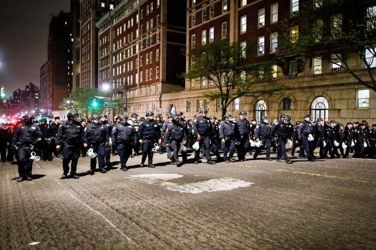 NYPD officers in riot gear march onto Columbia University.
