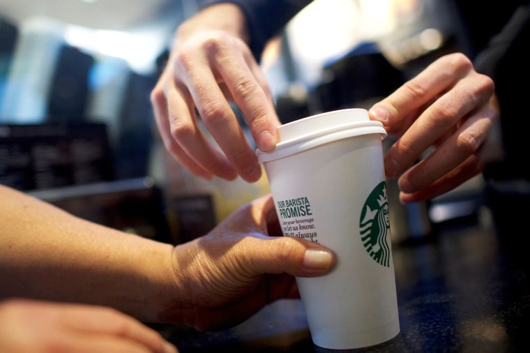 A Starbucks barista fulfills an order in a South Philadelphia store