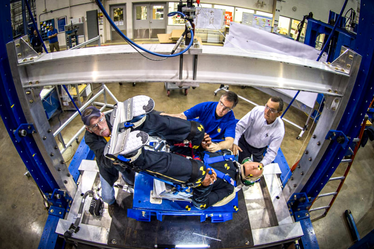 Engineers working with Boeing's CST-100 Starliner test the spacecraft's seat design.